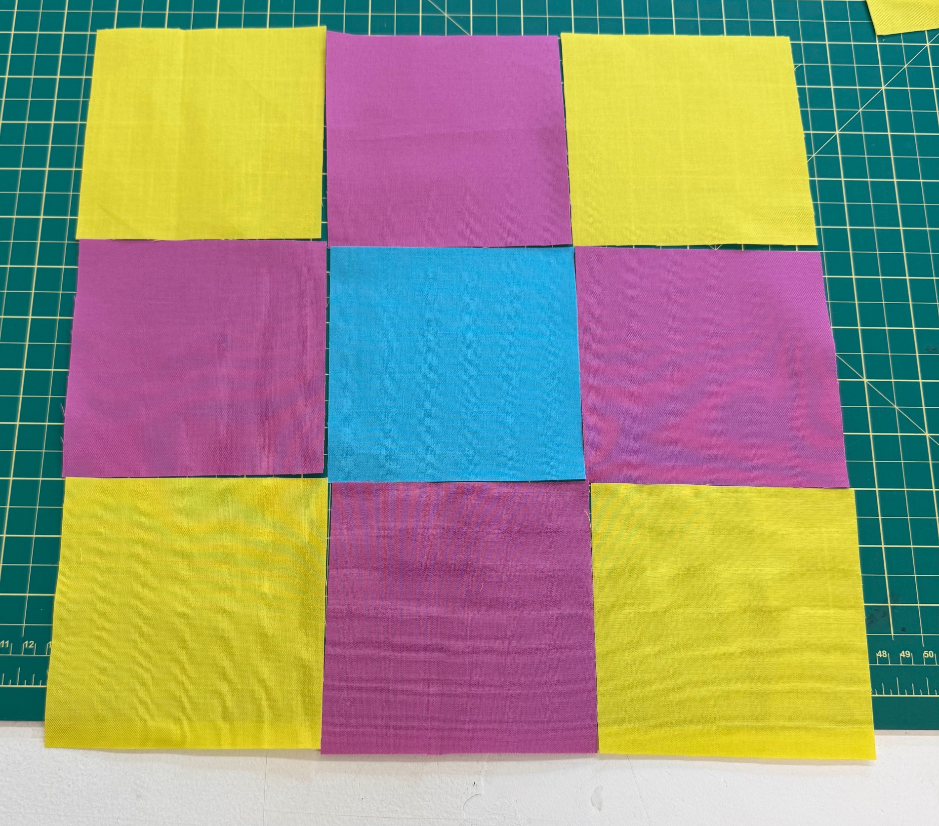 My 9-patch squares laid out on the cutting mat